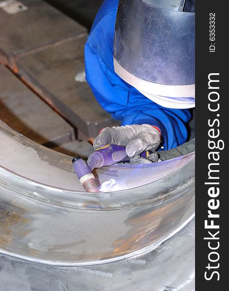 A metal welder busy at work. A metal welder busy at work