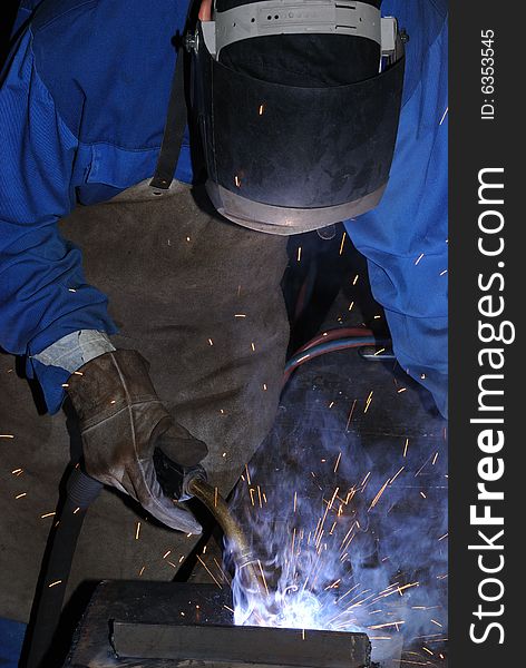 A metal welder busy at work. A metal welder busy at work