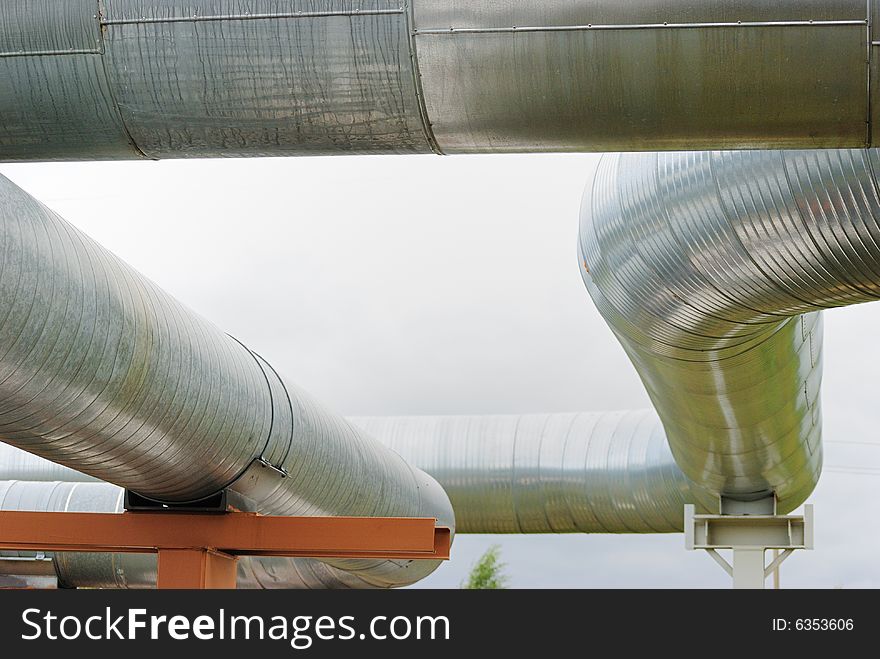 Industrial pipelines against blue sky