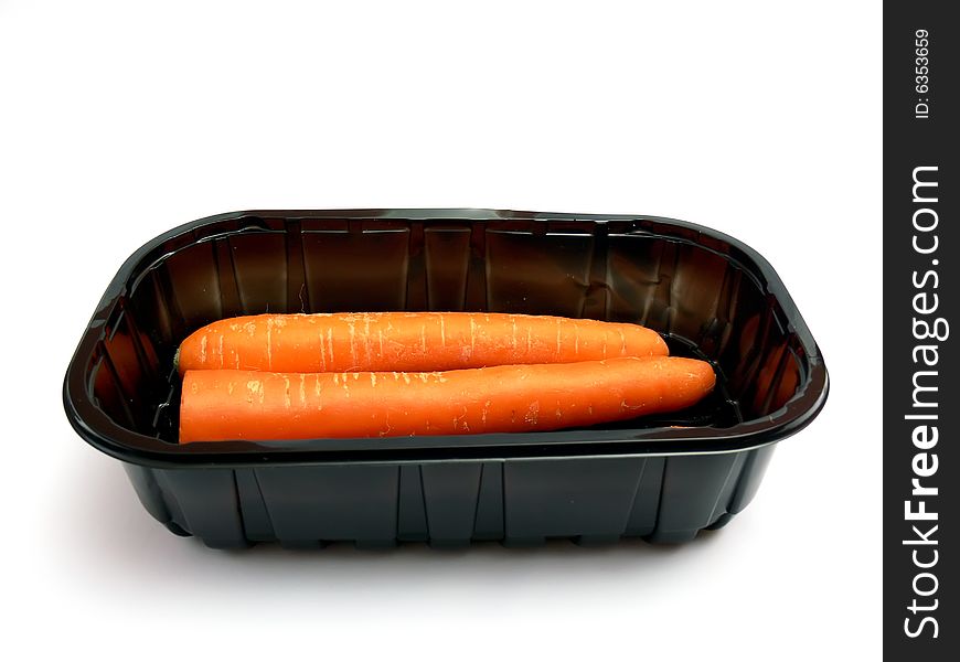 Wrapped carrot in a black plastic box isolated on a white background.