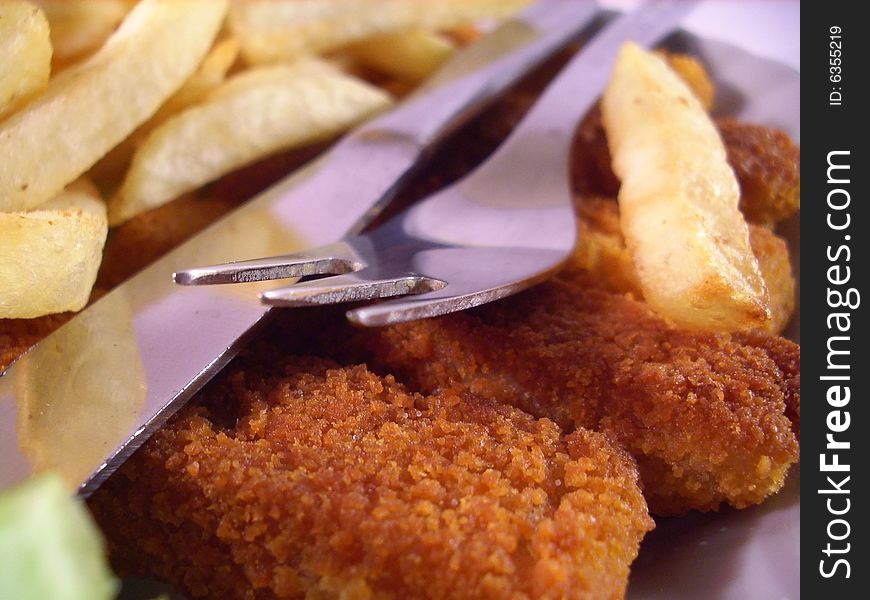 Isolated plate  with chips and fish sticks. Isolated plate  with chips and fish sticks