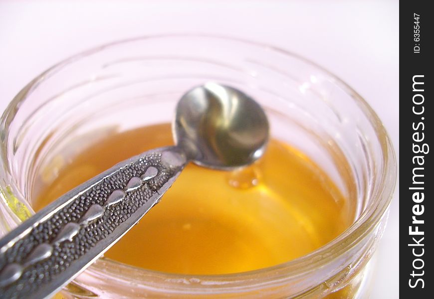 Closeup shot of honey in jar. Closeup shot of honey in jar