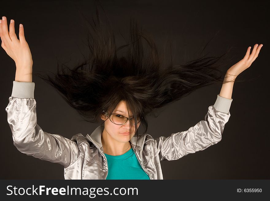 Beautiful girl shaking her hair isolated on black background