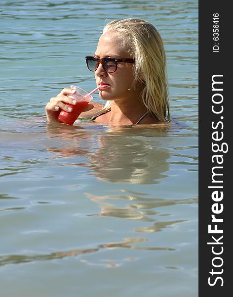 A girl with Strawberry Drink in the water. A girl with Strawberry Drink in the water