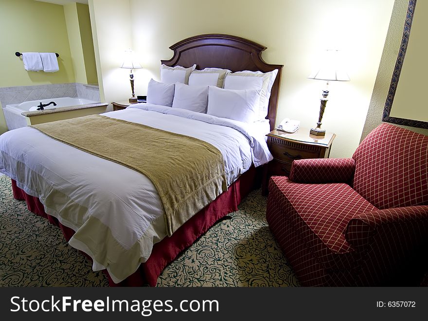 Hotel Bedroom With Tub And Chair