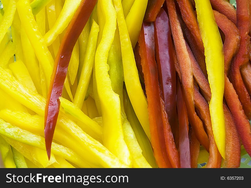 Red and yellow peppers cut into strips. Red and yellow peppers cut into strips