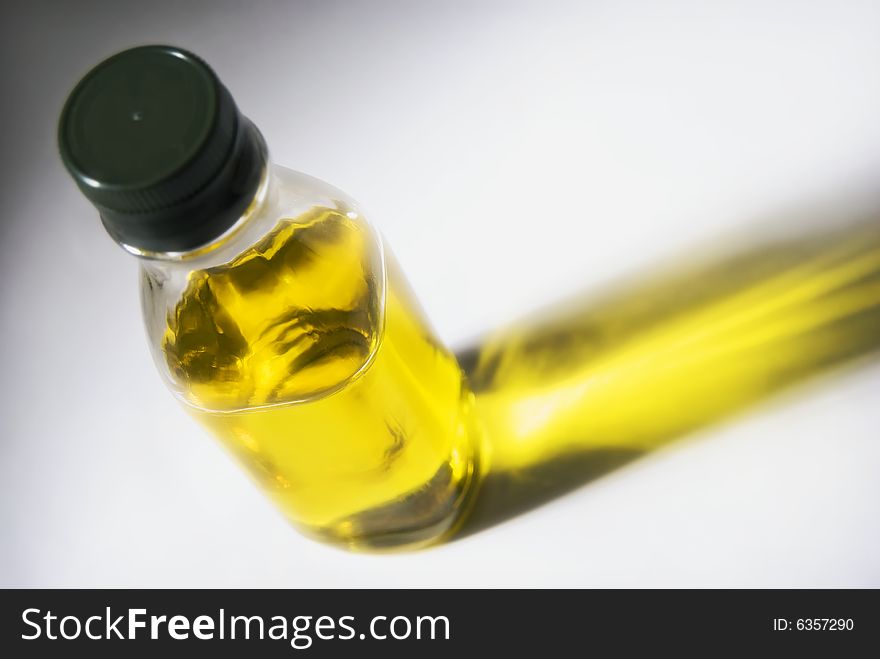 A bottle of olive oil against white background