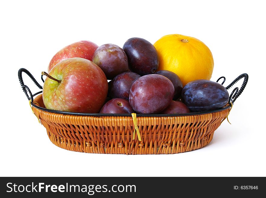 Basket with fruits on white