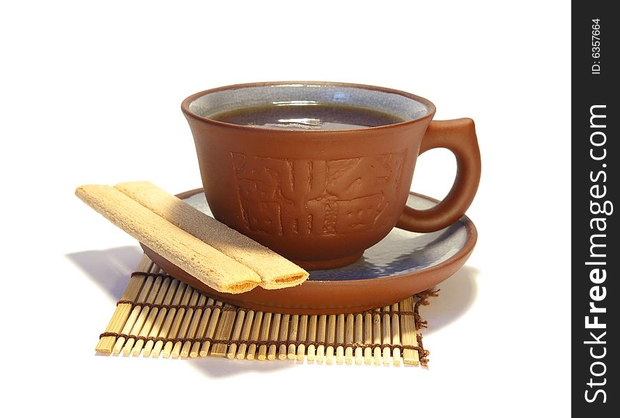 Ceramic cup of tea and cookies on white