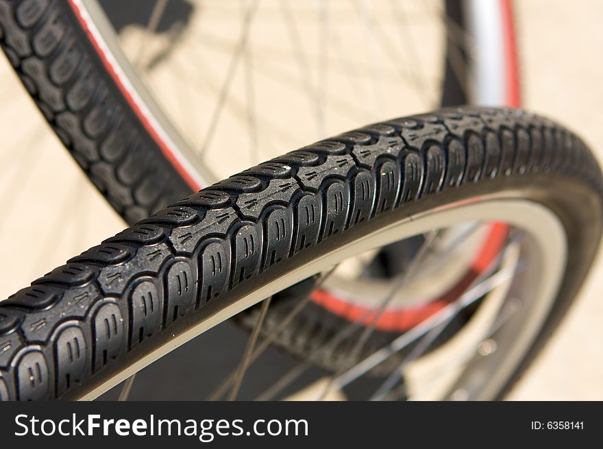 A close up image of bicycle tires. A close up image of bicycle tires