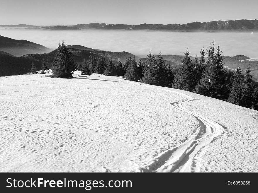 The large flat snow area in the mountains with ski track in free snow. The large flat snow area in the mountains with ski track in free snow