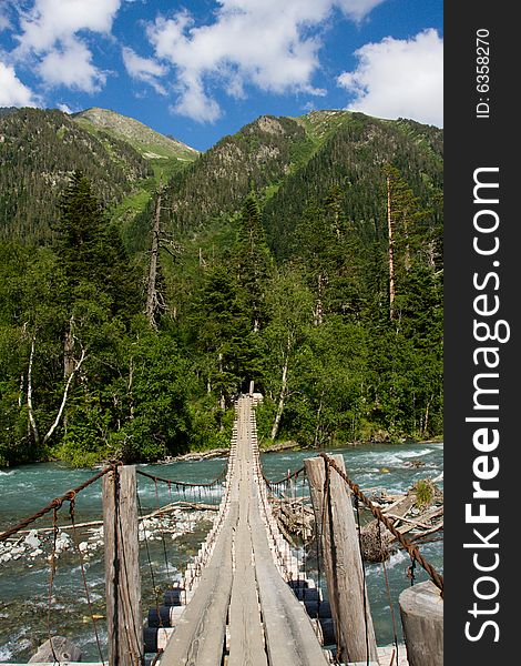 Suspension bridge over mountain river. Suspension bridge over mountain river