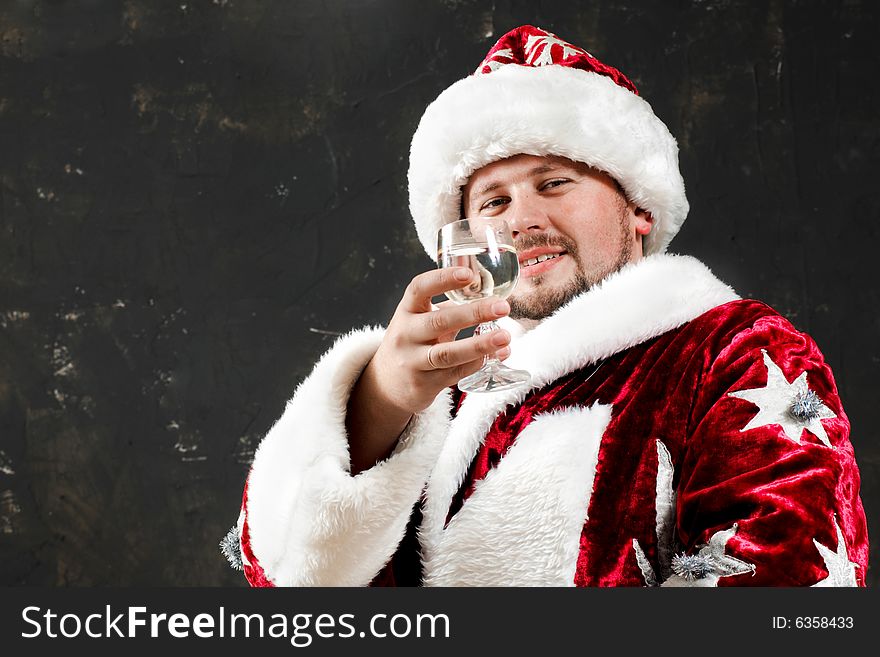 Santa Claus is preparing to celebrate Christmas. Drinking wine. Santa Claus is preparing to celebrate Christmas. Drinking wine