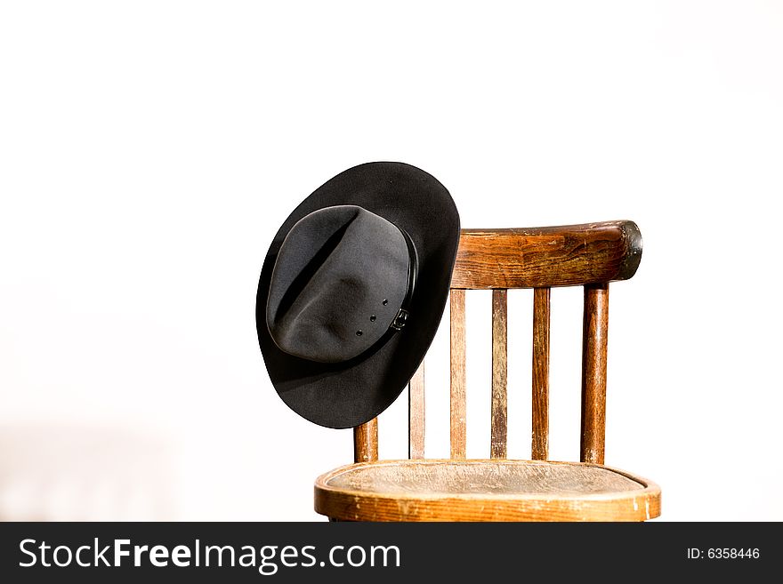 An image of wooden chair with hat