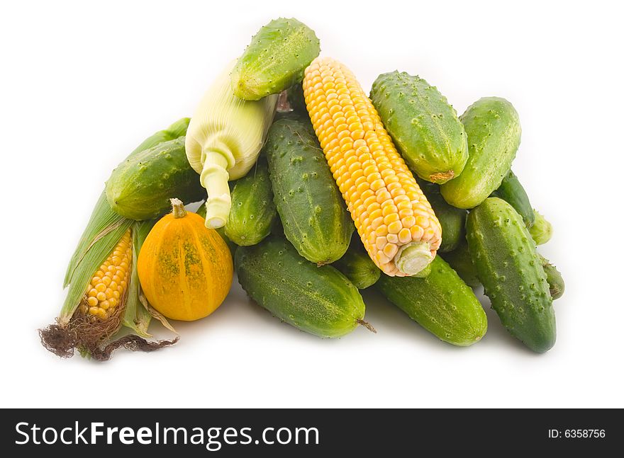 Cucumbers with corn and a pumpkin on a white background