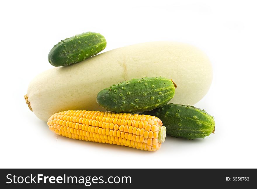 Vegetable marrow with corn and cucumbers on a white background