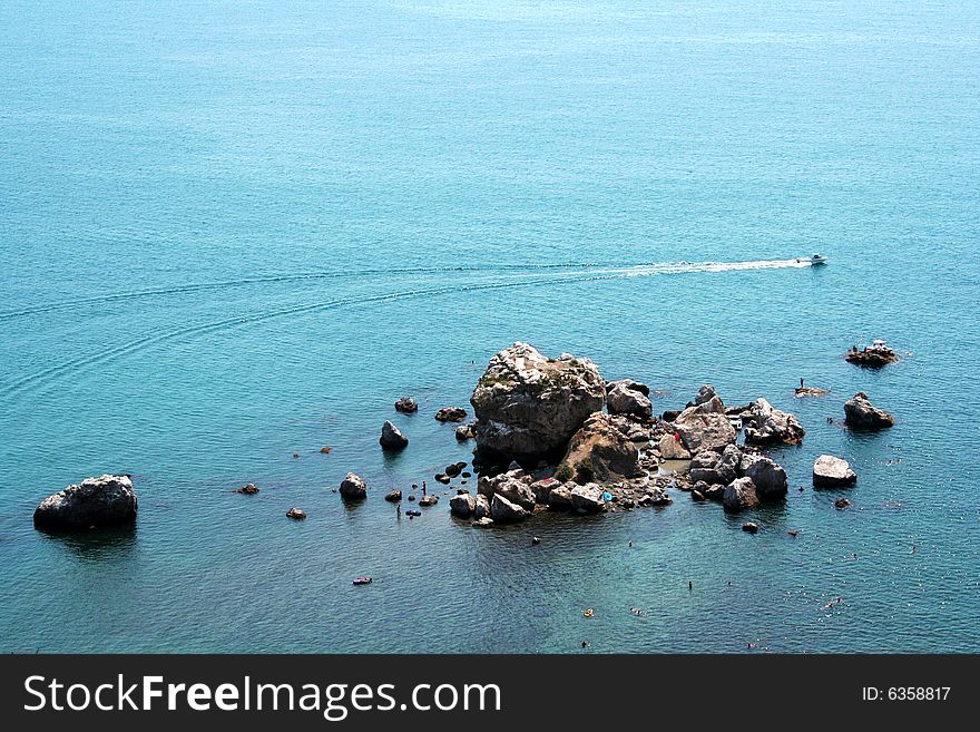 Picture of gulf nearby Sudak on Crimea Ukraine, with rocks and motor boat