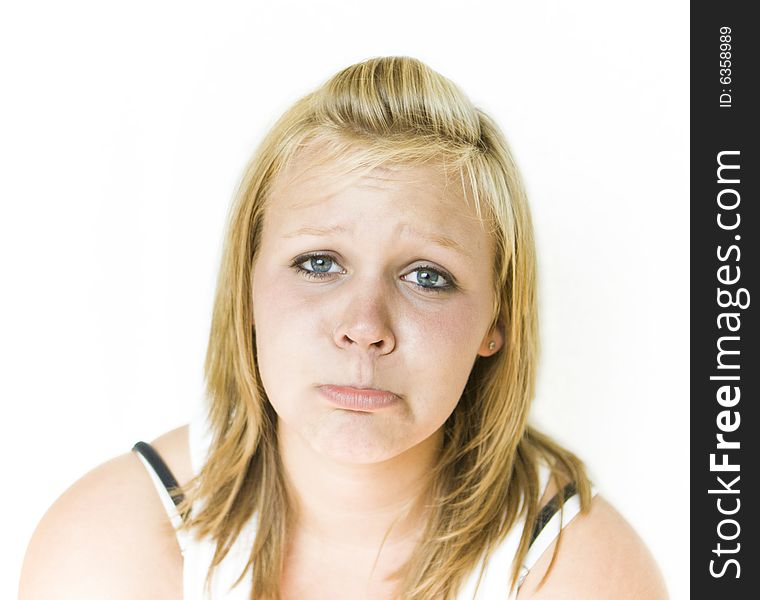 Young teenage girl looking sad. Isolated on white background. Young teenage girl looking sad. Isolated on white background