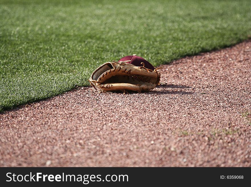 Baseball glove and baseball on the field