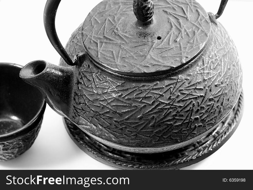 This is a shot of a Chinese tea pot and cup.