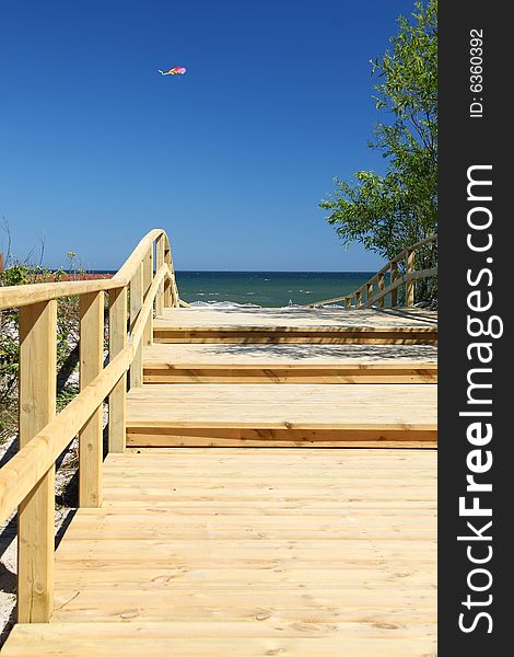 Wooden pier with blue sky and small kite. Wooden pier with blue sky and small kite