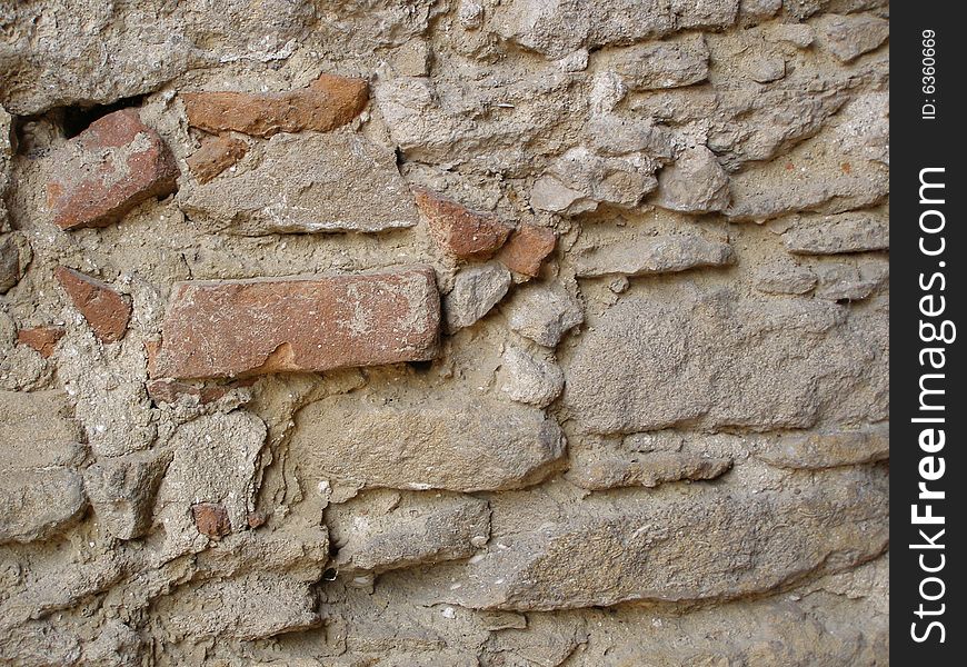 An old shabby stone wall. An old shabby stone wall