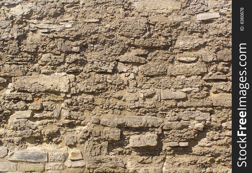 An old shabby stone wall. An old shabby stone wall