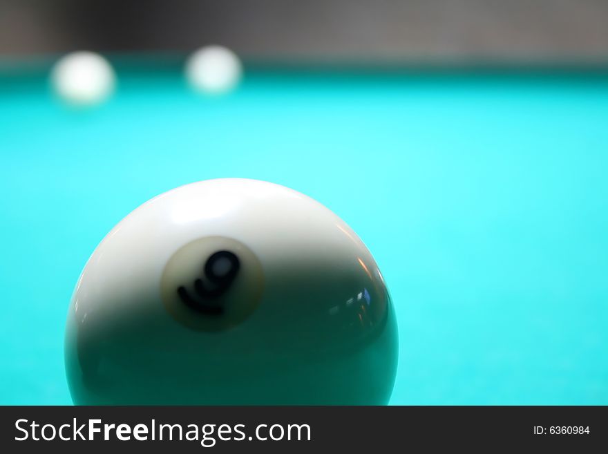 White billiard ball on a green pool table. White billiard ball on a green pool table