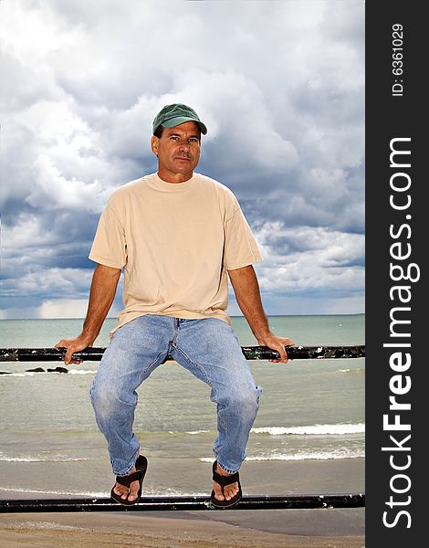 A mature man posing by Lake Erie on a dramatically cloudy day. Location suburb of Cleveland Ohio. A mature man posing by Lake Erie on a dramatically cloudy day. Location suburb of Cleveland Ohio.