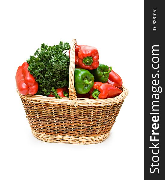 A basket of red, green peppers and parsley. A basket of red, green peppers and parsley.