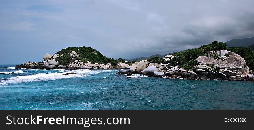 Caribbean rock island with storm coming