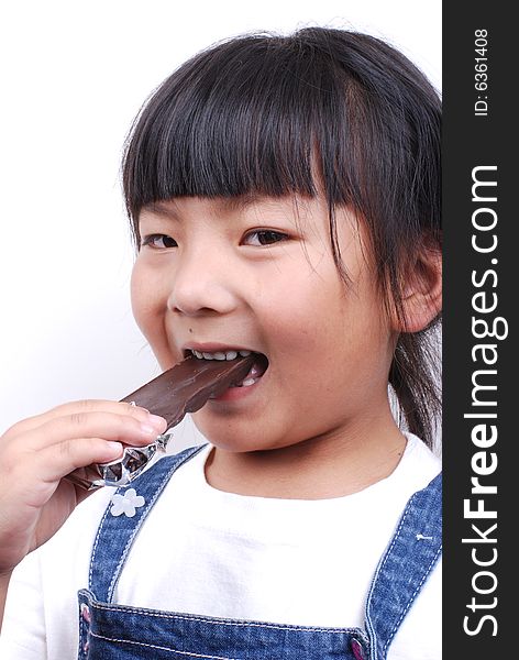 Asia girl eating a chocolate  . Asia girl eating a chocolate  .