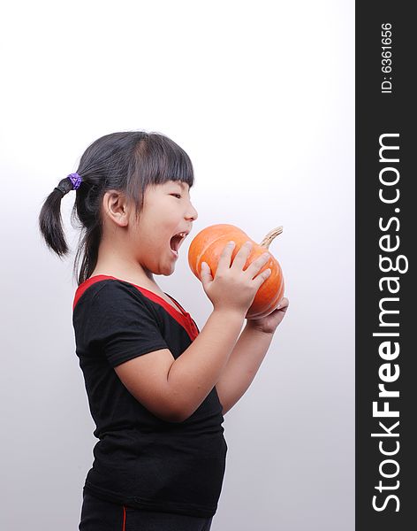 Asia girl eating pumpkin on white background. Asia girl eating pumpkin on white background