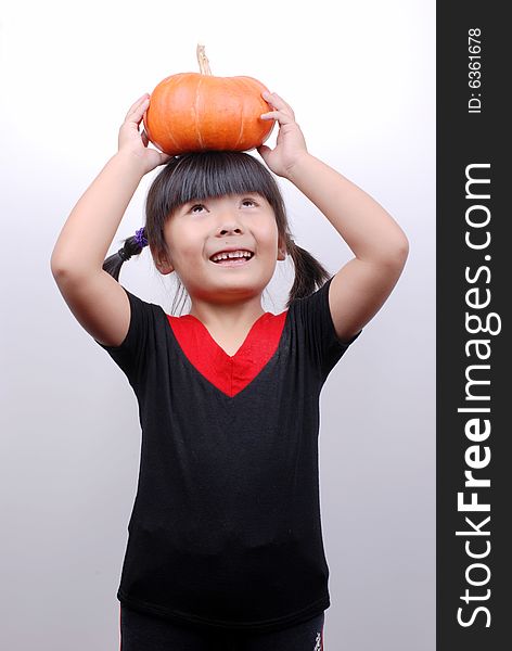 Asia girl smiling with  pumpkin on white background. Asia girl smiling with  pumpkin on white background