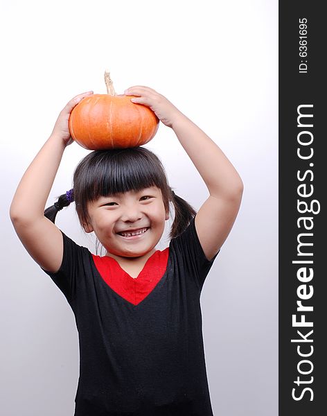 Asia girl shy and smiling with  pumpkin on white background. Asia girl shy and smiling with  pumpkin on white background