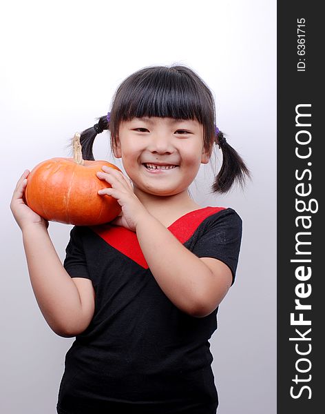 Asia girl shy and smiling with pumpkin on white background. Asia girl shy and smiling with pumpkin on white background