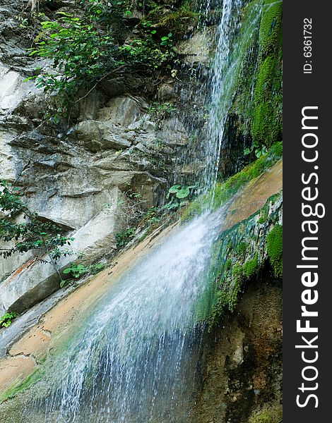 Waterfall, green trees and rocks