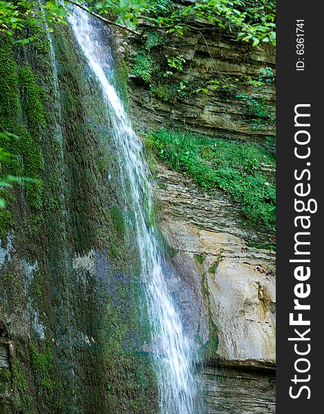 Waterfall in the forest. Caucasus Mountains