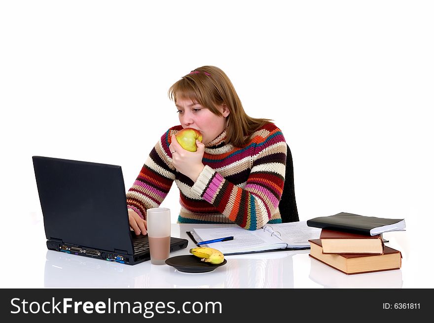 Teenager student doing homework with laptop and books on desk, with background, reflective surface