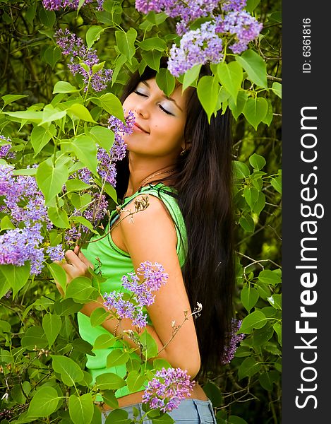 The beautiful girl and blossoming lilac. The beautiful girl and blossoming lilac