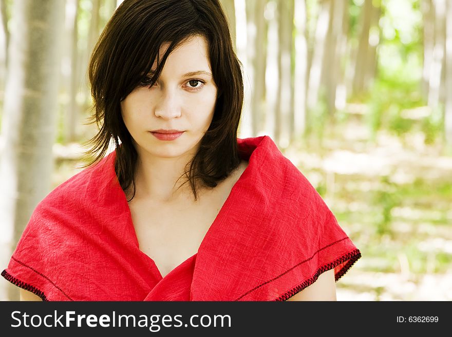 Beautiful woman staring at camera in a forest. Beautiful woman staring at camera in a forest.