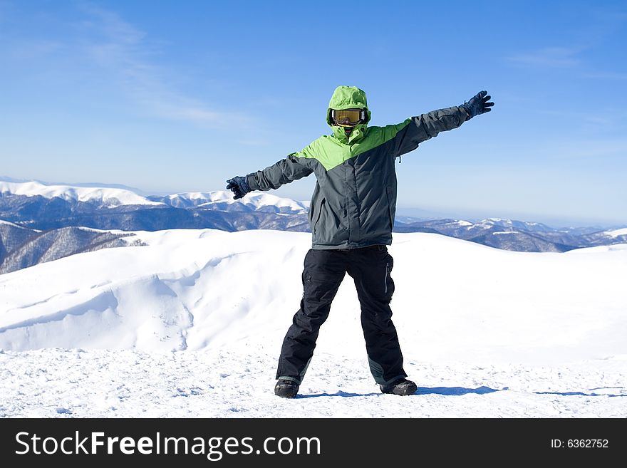 The snowboarder on a background of the blue sky