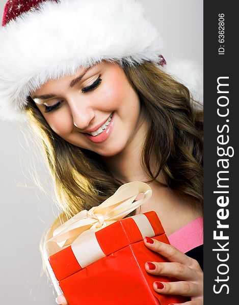 Winter portrait of a beautiful young smiling woman with a christmas cap. Winter portrait of a beautiful young smiling woman with a christmas cap