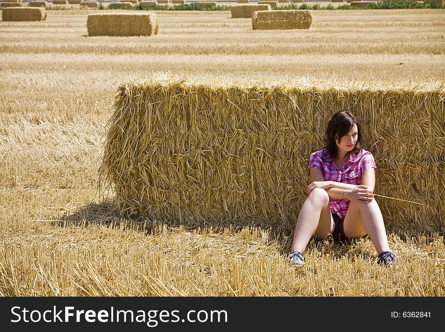 Young woman in haystack