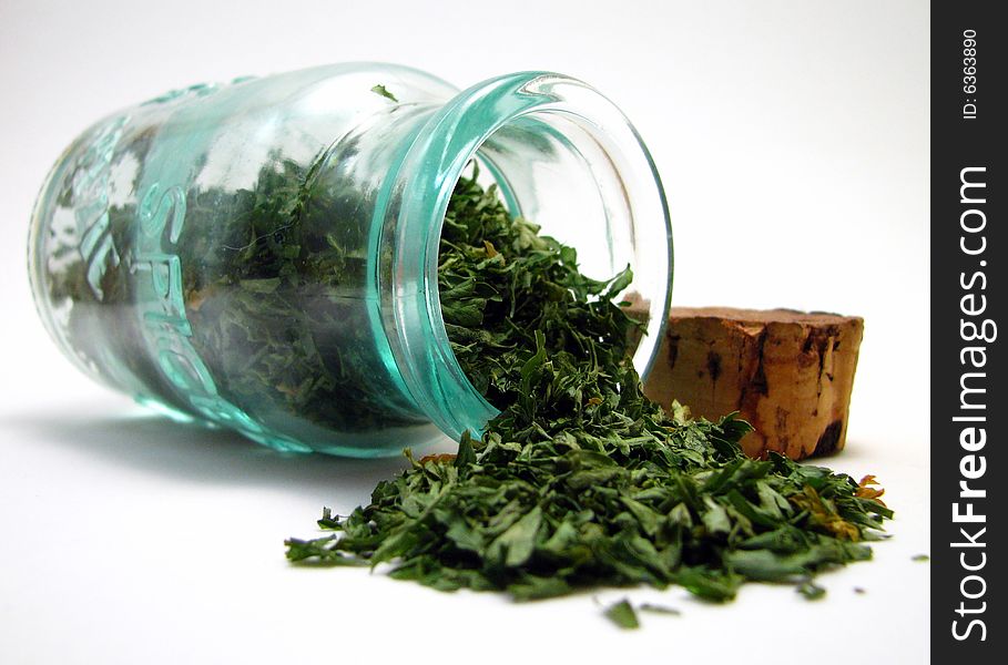 Dried parsley spilling out of it's jar