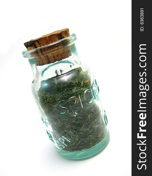 Dried parsley in a green jar. Dried parsley in a green jar