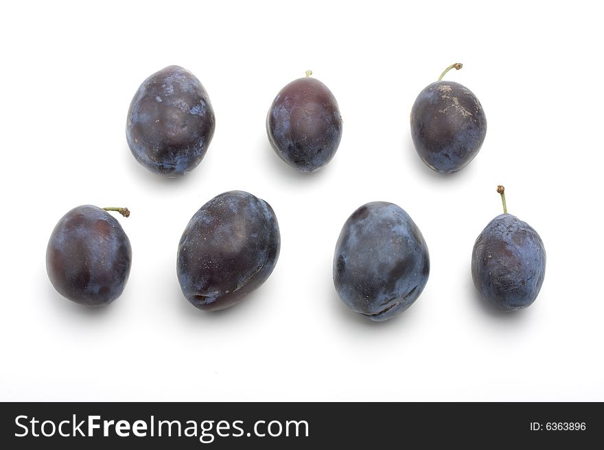 Fresh plums on white background