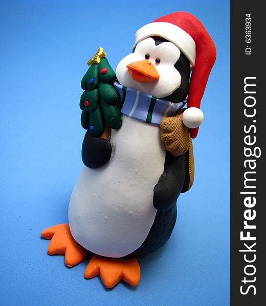 A christmas penguin figurine on a light blue background