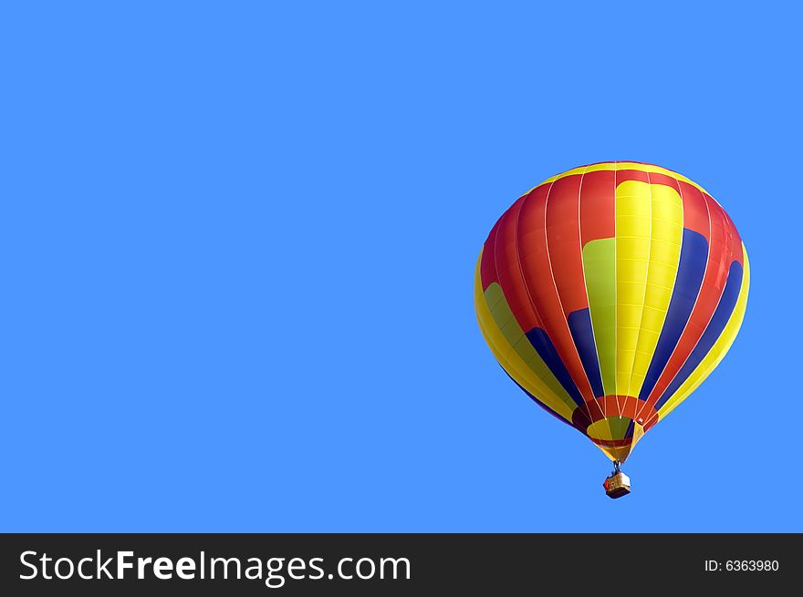 Colored Hot Air Balloon on solid blue sky background