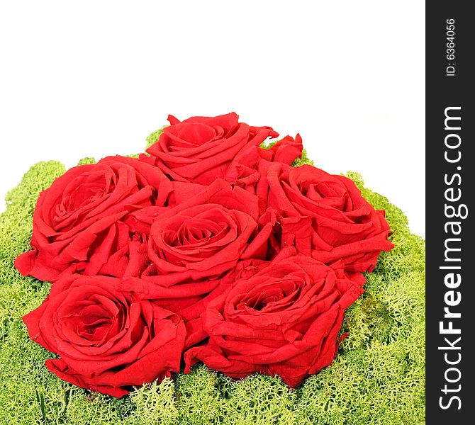 Bunch of red roses with green decor isolated